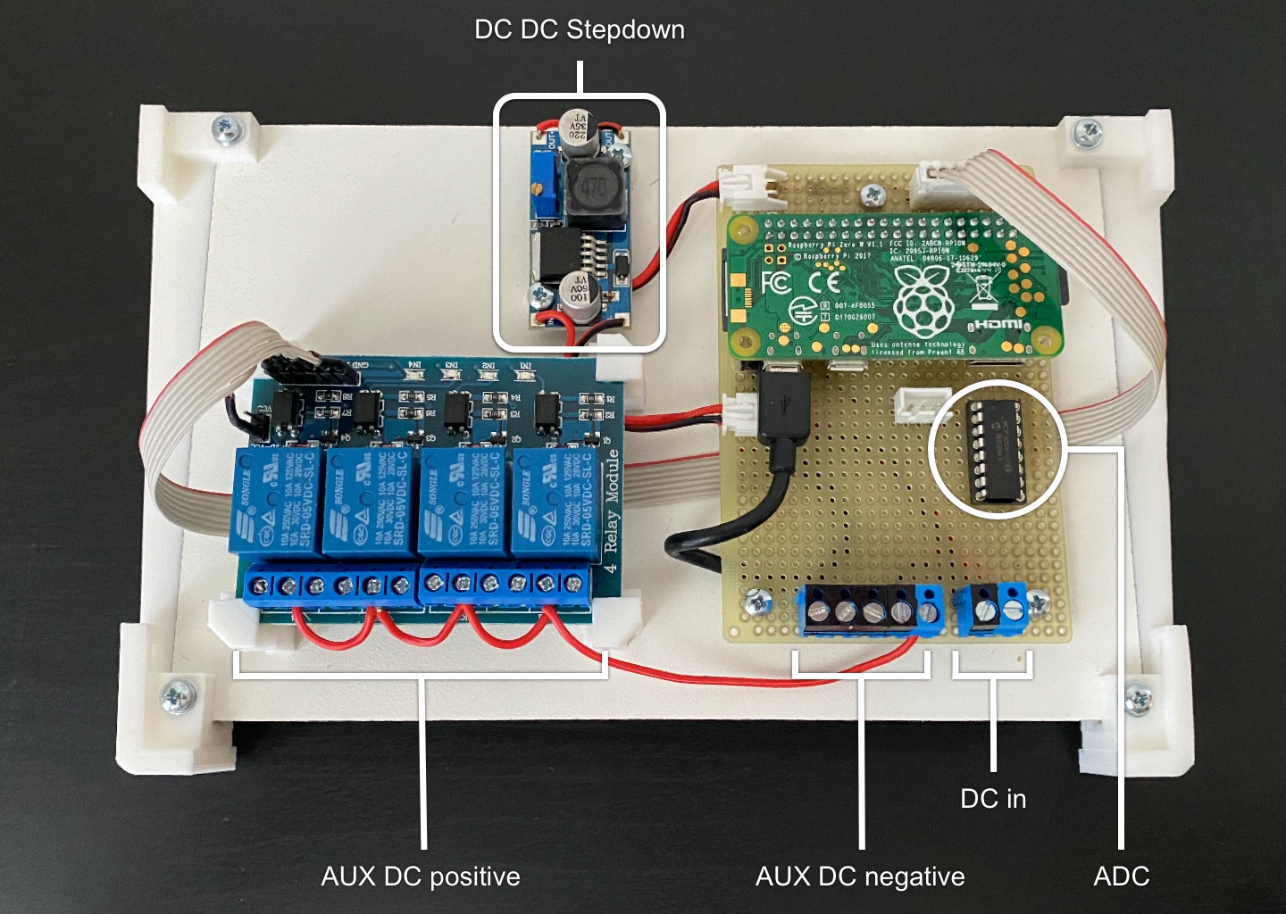 The main components are organized on a piece of wood which is housed outdoors in a waterproof box.